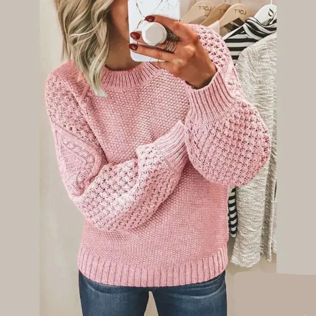 Woman wearing a textured knit sweater with crew neckline and open-stitch sleeve detailing._0