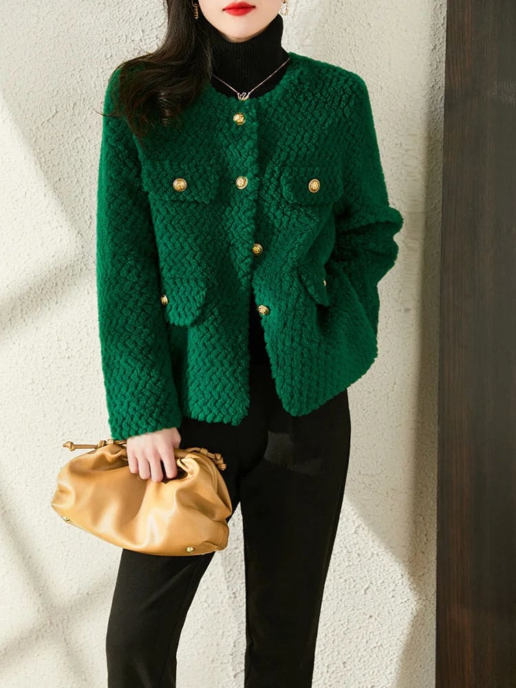 Woman wearing a textured short jacket with gold buttons in a tailored silhouette, viewed from behind._23