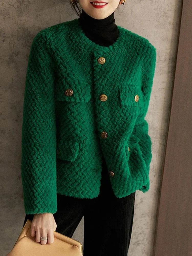 Woman wearing a textured short jacket with gold buttons in a tailored silhouette, viewed from behind._8