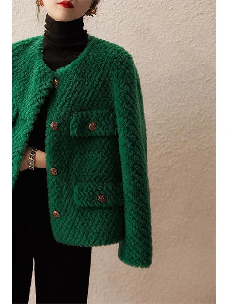 Woman wearing a textured short jacket with gold buttons in a tailored silhouette, viewed from behind._9