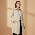 Woman wearing a beige trench coat with structured collar, button front, and side pockets over a white top and black pants._0