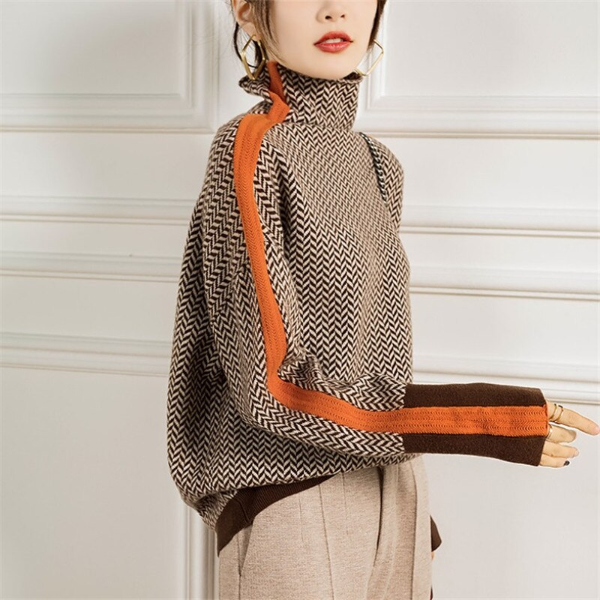 Woman wearing a herringbone knit turtleneck sweater with ribbed trim, styled with light trousers and a crossbody bag._0