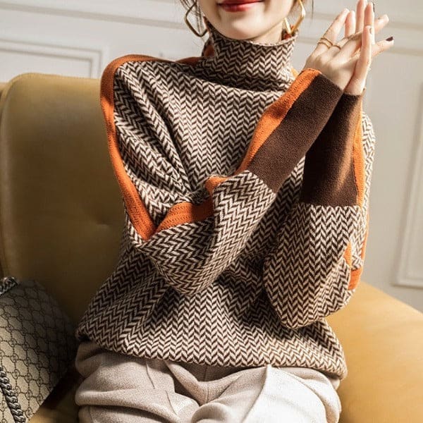 Woman wearing a herringbone knit turtleneck sweater with ribbed trim, styled with light trousers and a crossbody bag._2