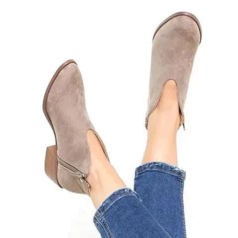 Taupe V-cut ankle boots shown from above with their low block heels and side zipper details visible.