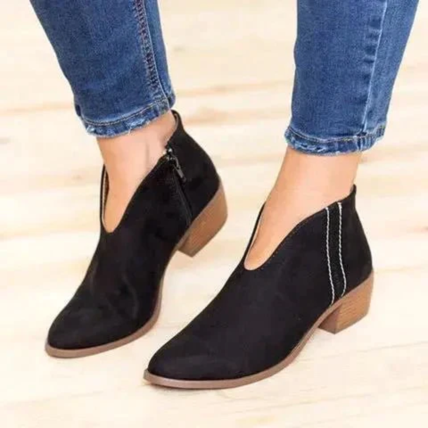 Black V-cut low heel ankle boots styled with cropped jeans, highlighting the pointed toes and contrasting heel.