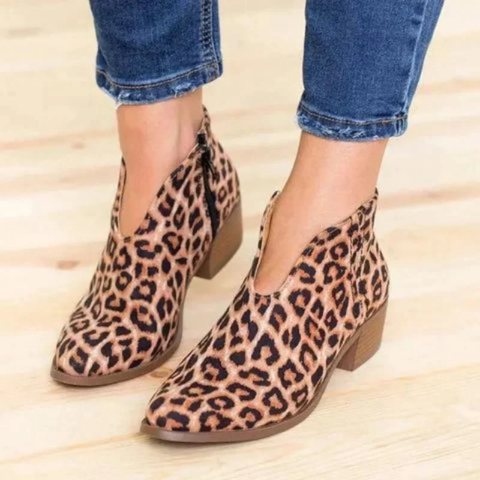 Leopard-print V-cut ankle boots with low block heels worn with cropped blue jeans.