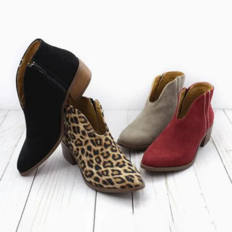 A group of V-cut low heel ankle boots in black, leopard print, taupe, and red, showing the available color and pattern options.