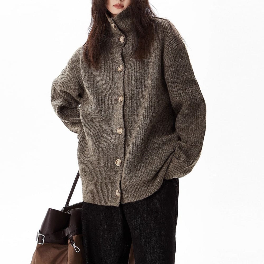 A model wears a relaxed button front cardigan with a foldover collar over a dark top and wide-leg pants._1