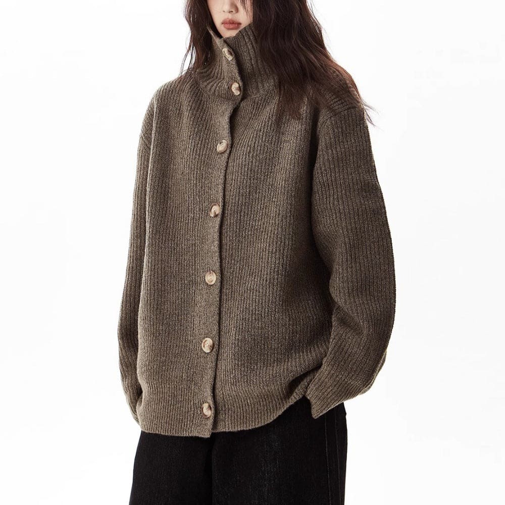 A model wears a relaxed button front cardigan with a foldover collar over a dark top and wide-leg pants._2