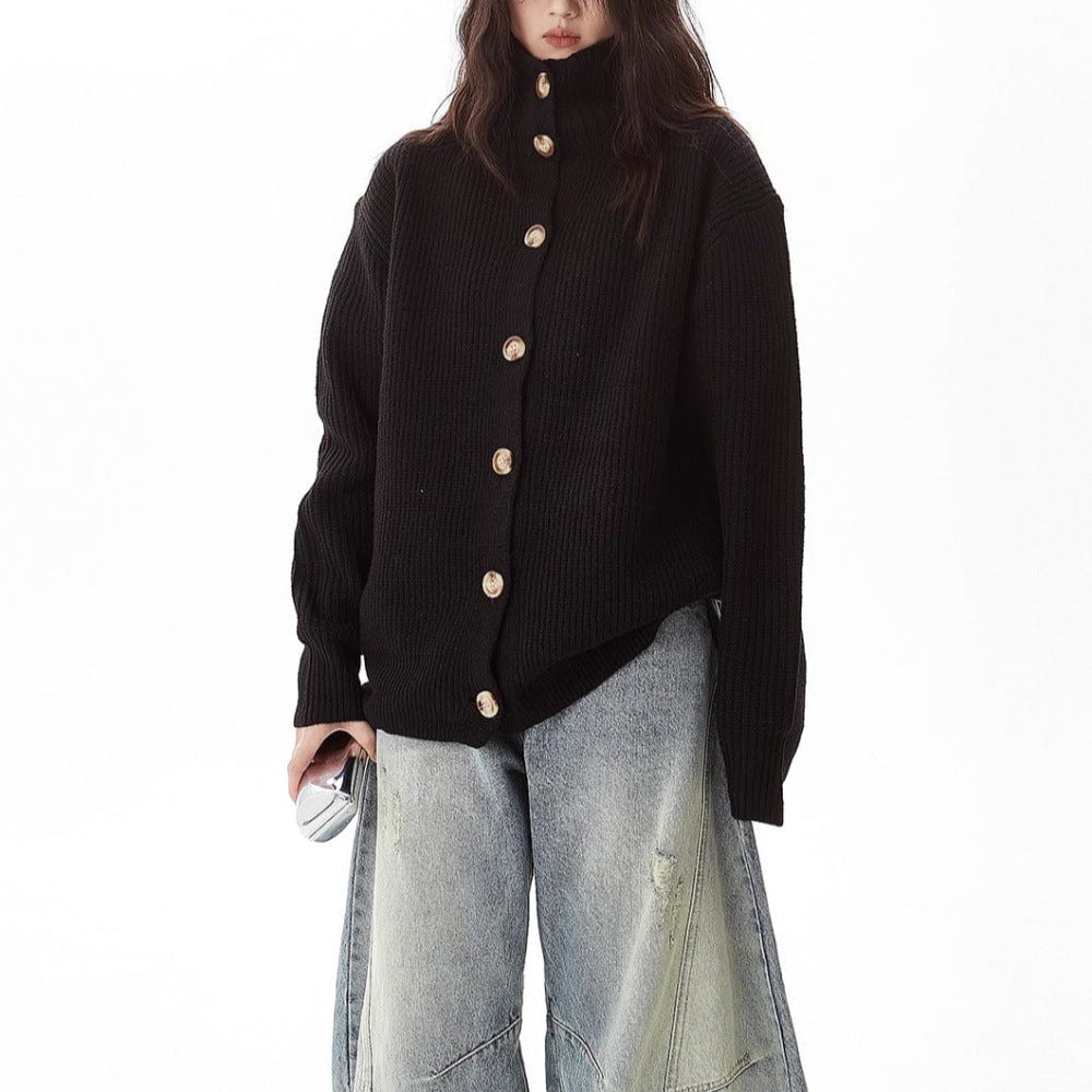 A model wears a relaxed button front cardigan with a foldover collar over a dark top and wide-leg pants._3