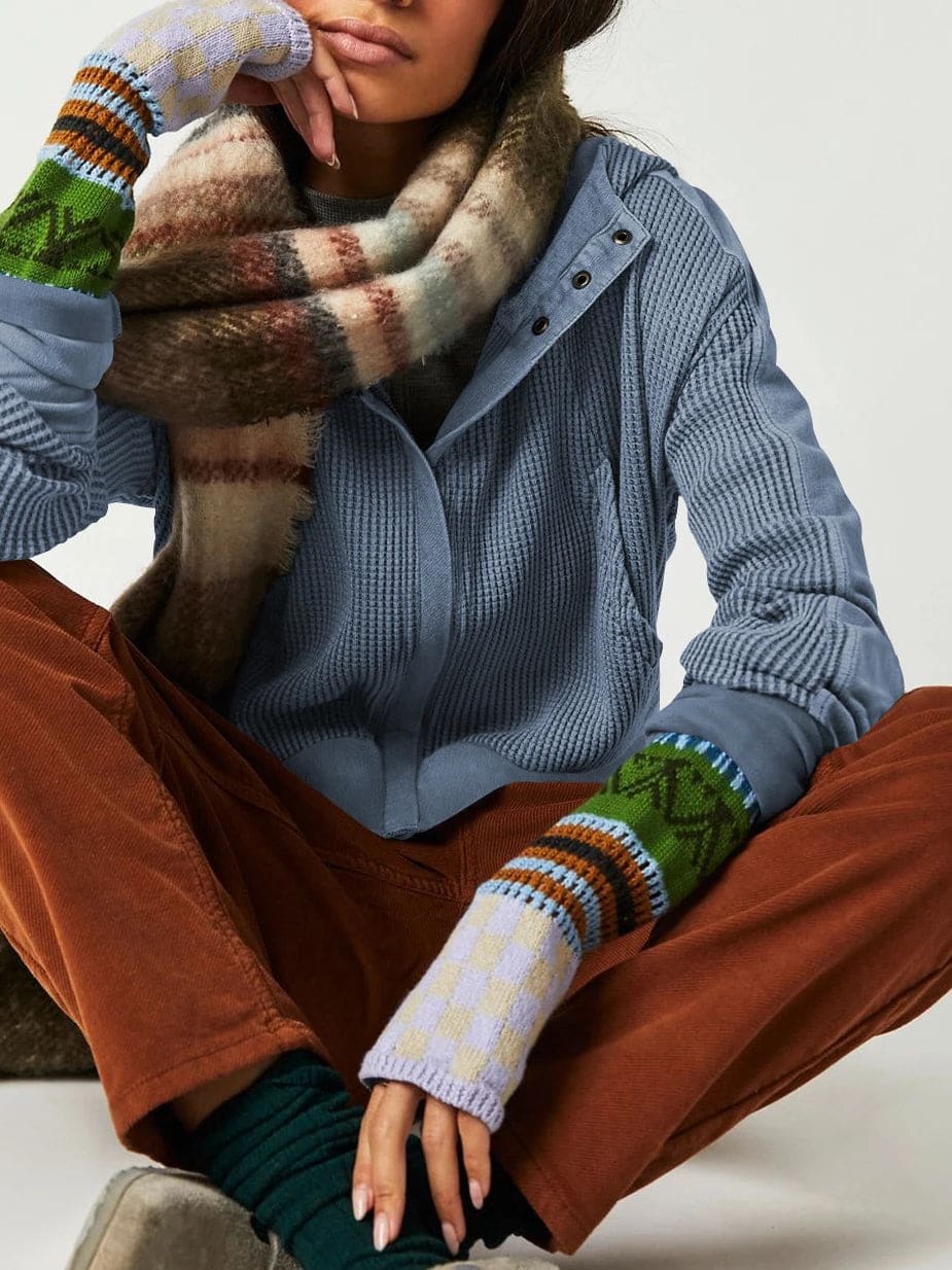 Model wearing an olive green waffle knit zip-up hoodie with cropped length and hood, styled with brown pants._24