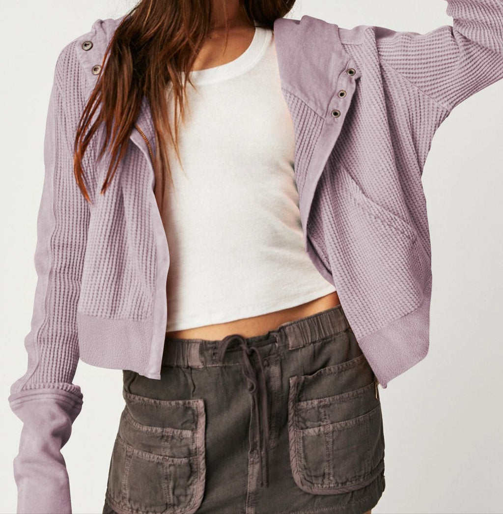 Model wearing an olive green waffle knit zip-up hoodie with cropped length and hood, styled with brown pants._37