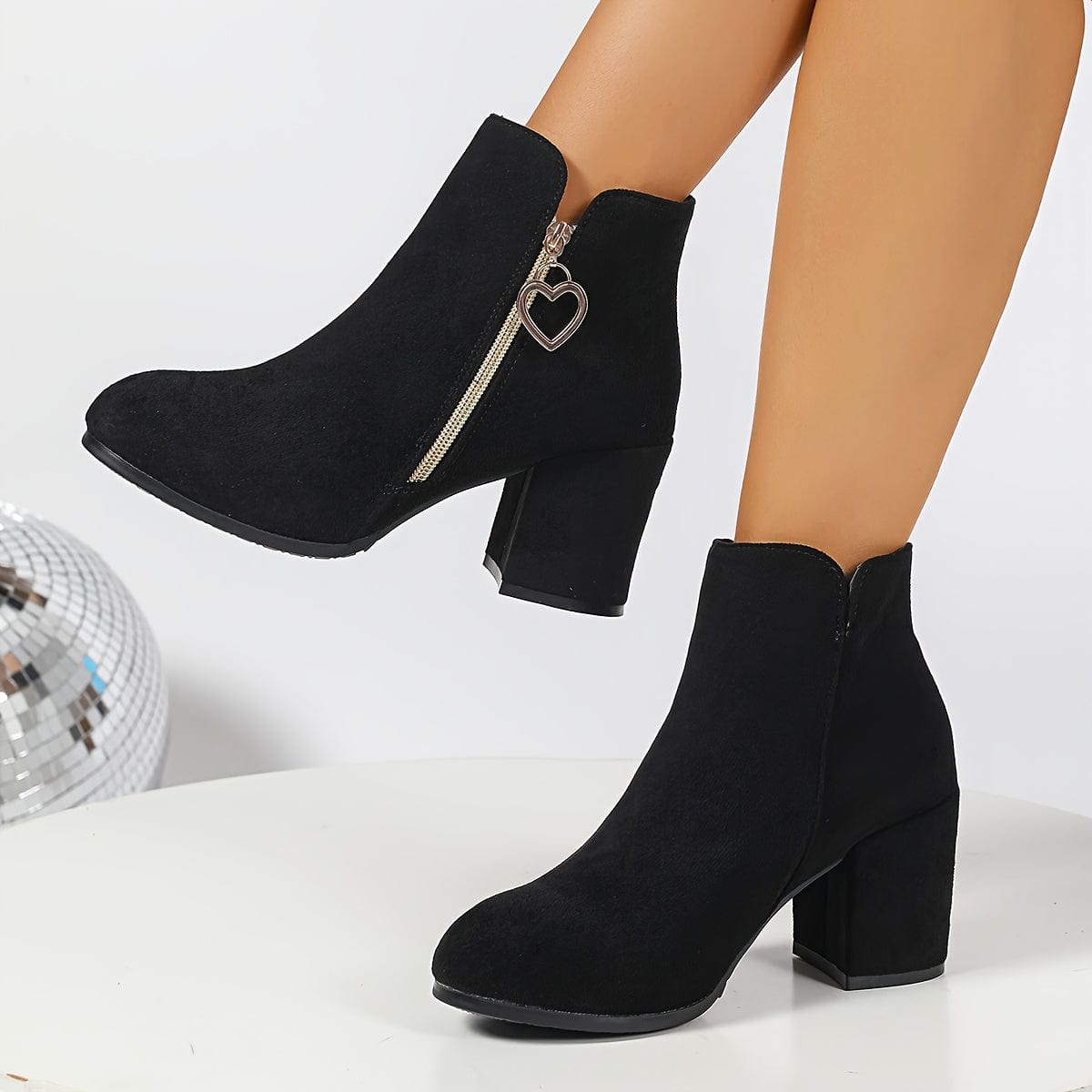 Pair of ankle boots with block heel, side zipper with gold heart charm, and elastic panel for easy wear._6
