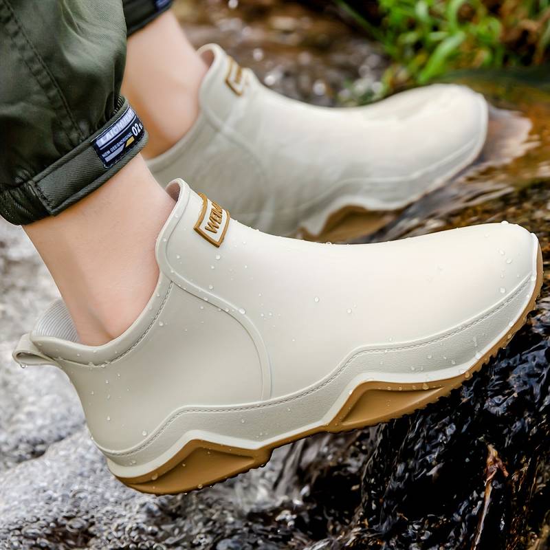 Side view of a slip-on ankle boot in a neutral tone with a contoured sole and pull tab at the heel._4