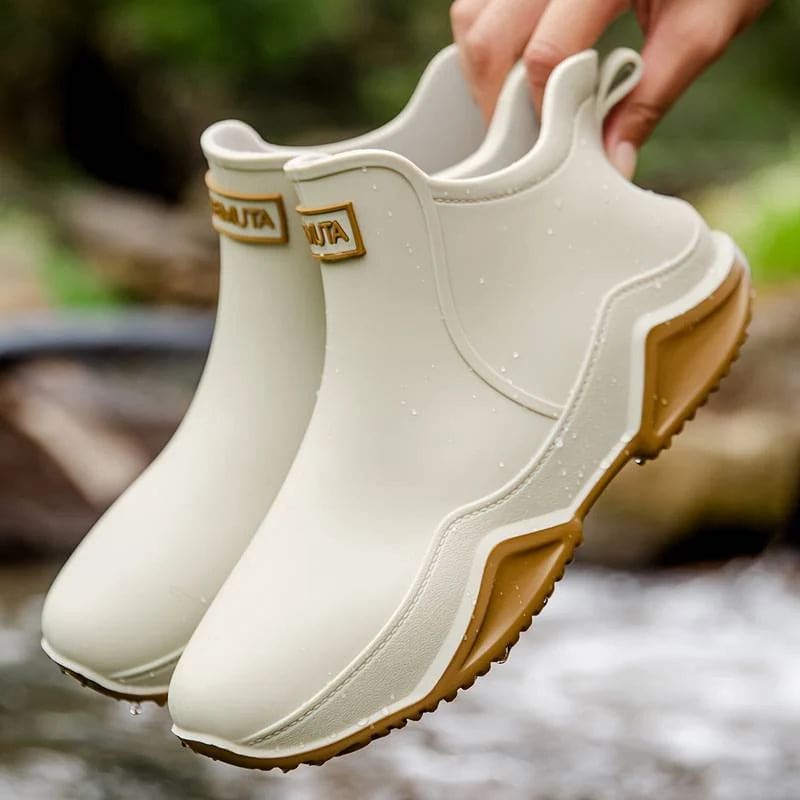 Side view of a slip-on ankle boot in a neutral tone with a contoured sole and pull tab at the heel._5