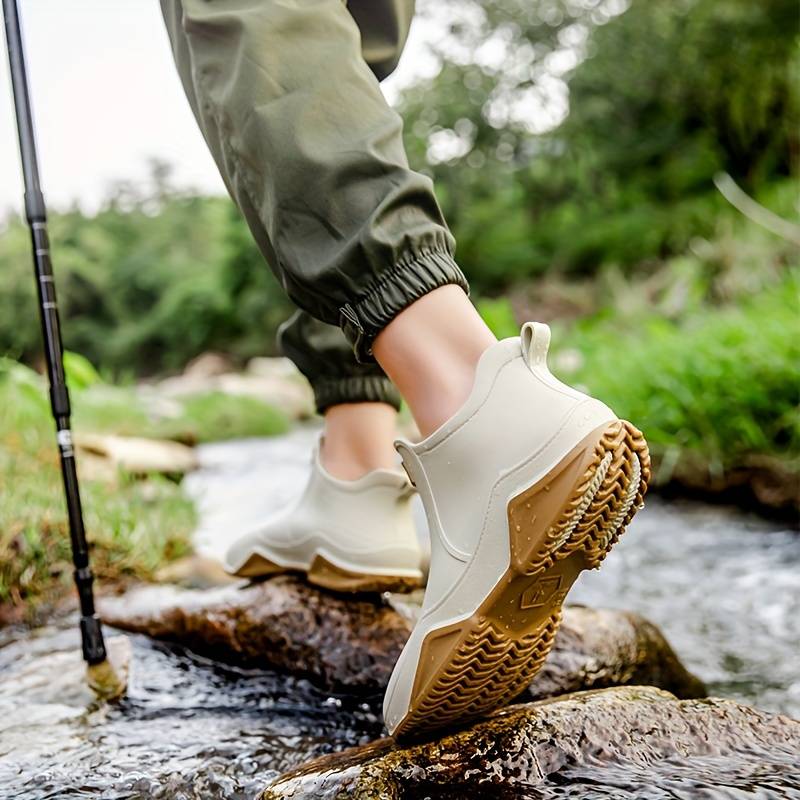 Side view of a slip-on ankle boot in a neutral tone with a contoured sole and pull tab at the heel._6