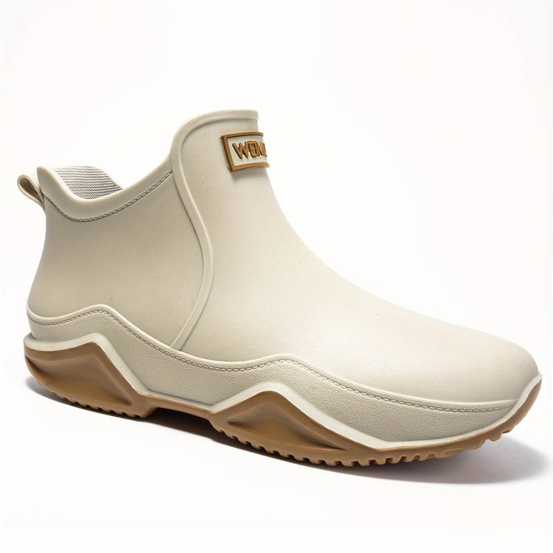 Side view of a slip-on ankle boot in a neutral tone with a contoured sole and pull tab at the heel._7