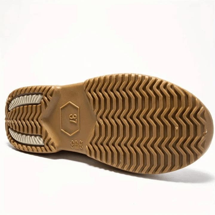 Side view of a slip-on ankle boot in a neutral tone with a contoured sole and pull tab at the heel._9