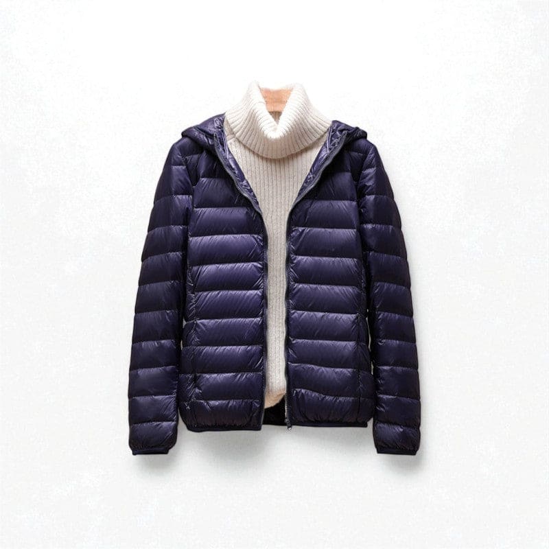 A hooded quilted puffer jacket with a front zip closure is shown layered over a light turtleneck._0