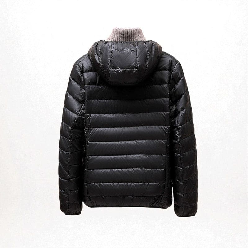 A hooded quilted puffer jacket with a front zip closure is shown layered over a light turtleneck._3