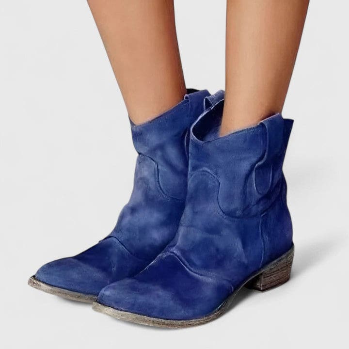 Woman wearing slouchy western ankle boots with a low stacked heel and textured finish_0